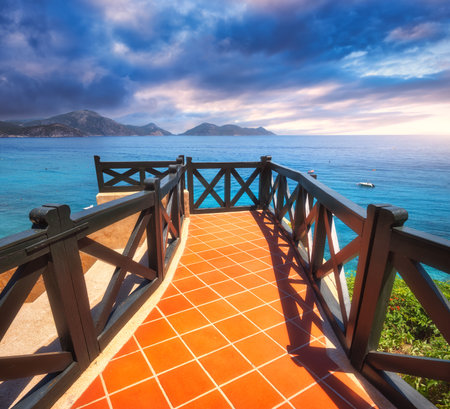 Beautiful view from balcony on blue sea, mountains and cloudy skyの写真素材