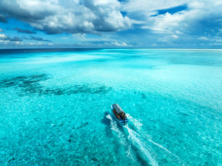 Aerial view of floating boat in turquoise water on sunny dayの写真素材