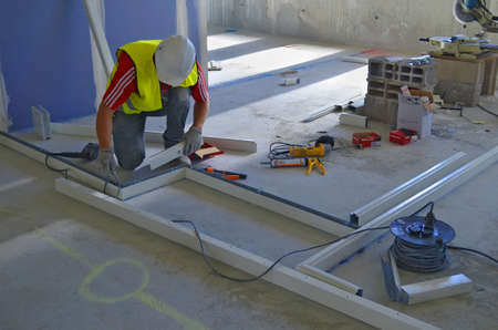 Besançon, France - July 17, 2014: Workman installing partitions on a construction site.のeditorial素材