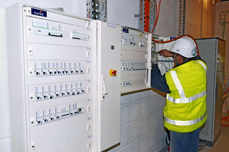 Besançon, France - January 23, 2015: Electrician wiring a switchboard on a construction site.のeditorial素材