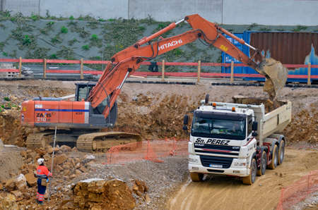 Besançon, France - May 24, 2013: High angle view of an excavator and a dump trunck on a construction site.のeditorial素材