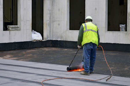 Besançon, France - February 18, 2014: Waterproofness work on a construction site.のeditorial素材
