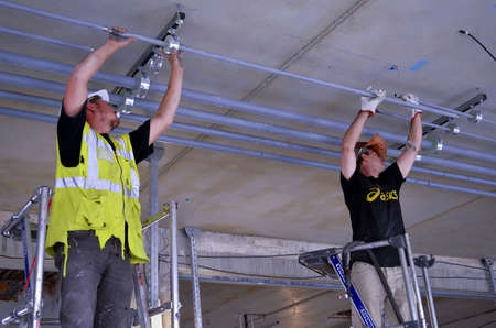 Besançon, France - May 21, 2014: Workers installing pipings on a construction site.のeditorial素材