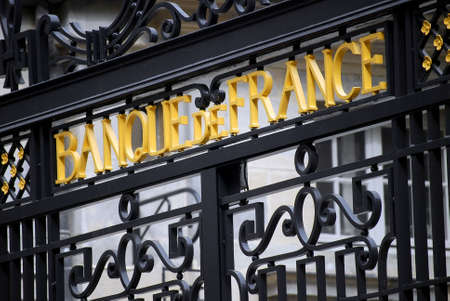 Besançon, France - May 3, 2009: Low angle view of the wrought iron gate of the Bank of France building with the yellow letters of the signboard.のeditorial素材