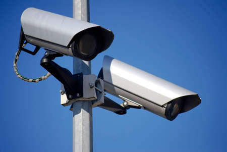 CCTV cameras against a blue sky