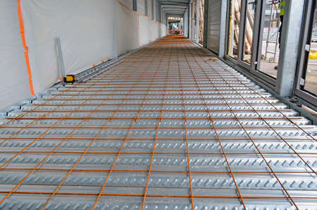 Preparation of the concrete slab with an iron mesh on a construction siteの写真素材