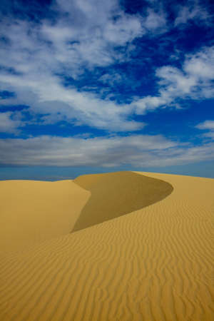 A sand dune under a blue sky in Vietnamの写真素材