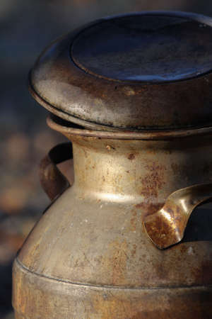 An antique milk container, aged and rusted by the passage of timeの写真素材