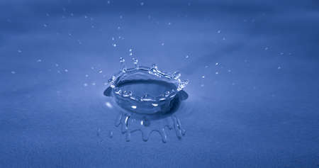 Splash of water captured with high speed macro photo - Dark Blue gel filter - Shallow depth of field - Horizontalの写真素材