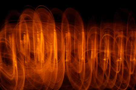 Abstract orange light streaks paint. The long exposure of a photograph taken in a dark environment...