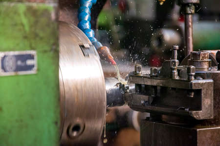 Turret lathe in operation for metal processing. Metalworking is the process of shaping and reshaping...