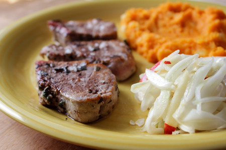 Pork tenderloin with sweet potatoes and fennel saladの写真素材