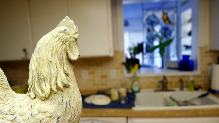 Carved wooden rooster in country kitchen.の写真素材
