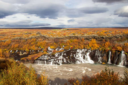 Waterfalls in Iceland in autumnal colours orangeの写真素材
