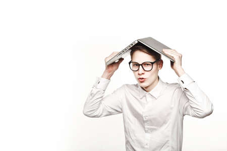 young man in glasses with laptop with emotion on white backgroundの写真素材