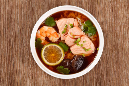 Asian soup with seafood, salmon, shrimp, lemon, mushrooms and riceの写真素材