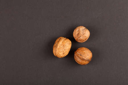three walnuts on black paperの写真素材