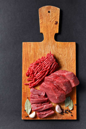 Fresh butcher cut meat assortment on black backgroundの写真素材