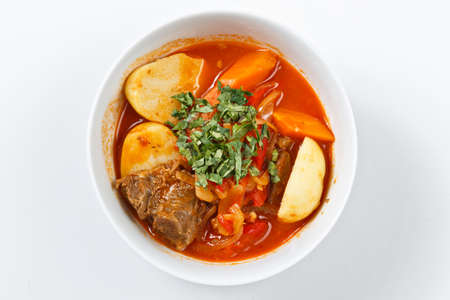 Shorba chuchvara soup national asian food in traditional bowls with spices and vegetables on canvas...