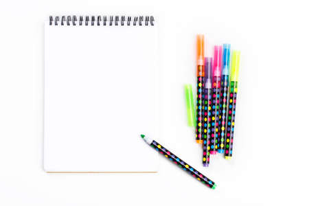 notepad with colorful markers on white background