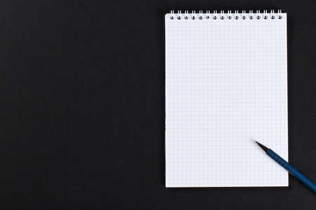 Blank notepad with pencil on office black table. template.の写真素材