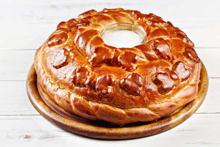 Russian wedding round loaf close-up on wooden table. Wedding bread with salt. Russian wedding ceremonyの写真素材