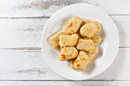 chicken naggets. fried nuggets chicken slices on wooden tableの写真素材