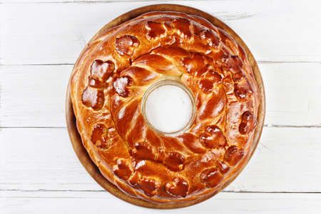 Russian wedding round loaf close-up on wooden table. Wedding bread with salt. Russian wedding ceremonyの写真素材