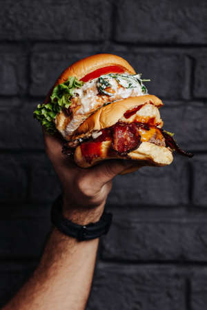 Premium patties burgers. Grilled chicken patty with fresh lettuce. Bacon and angus beef patty at the with melted cheese.の写真素材