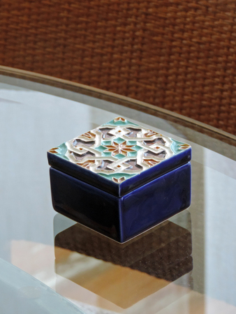 Small decorated box on a glass surfaceの写真素材