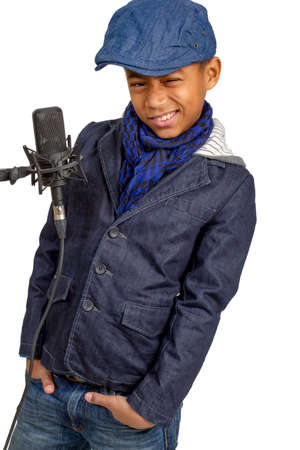 Beautiful mulatto boy posing near the microphone.の写真素材