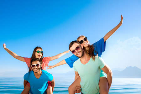 Tour by island. Tour operator. Ticket to the rest. Happy guys and girls at resort. Cheerful young people relaxing on the Mediterranean.の写真素材