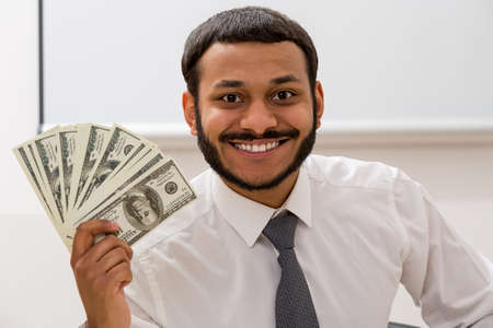 Manager keeps the dollars in hand. Clerk received a salary.の写真素材