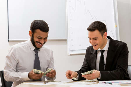 Successful clerks  count the money. Large sale. Business success.の写真素材