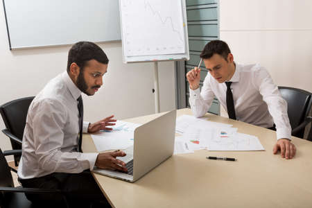 Young careerists develop a business plan. Creative business people discuss the project. Business men...