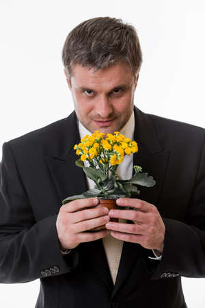 Man holds a flower in  hands. Clerk with a flower.の写真素材