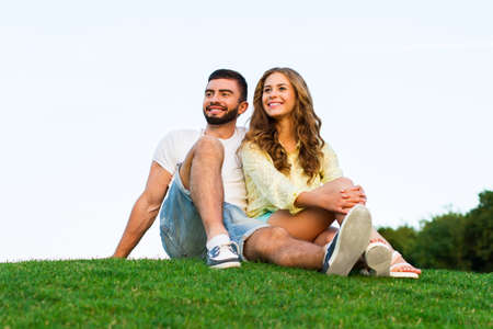 Lovers enjoying a date. Romantic date. Guy and a girl in love. Guy hugs girl. Honeymoon trip.の写真素材