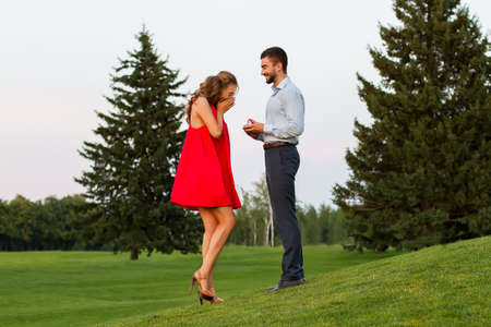 Guy puts on a ring his girlfriend. Guy confesses his love for his girlfriend. Guy makes a proposal...