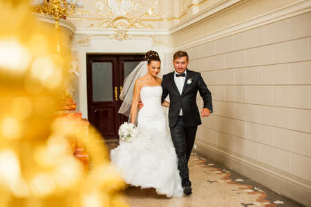 Newlyweds are walking in wedding palace. Wedding day.の写真素材