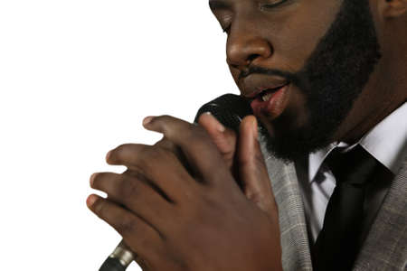 Elegant black man singing. Jazz performance by afroamerican. Professional singer on stage. Brilliant vocalist at his best.の写真素材
