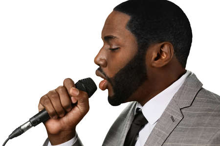 Darkskinned man sings jazz. Great jazz voice. Professional vocalist perfroming. Elegant black singer on stage.の写真素材