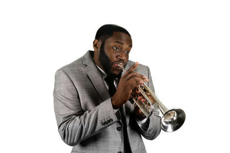 Professional musician on stage. Absorbed trumpet player. Black man playing trumpet music. Jazz perfrormer plays the trumpet.の写真素材