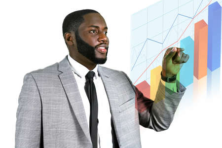 Looking at statistics. Darkskinned manager looking at charts. Initiating progress check. The income is growing.の写真素材