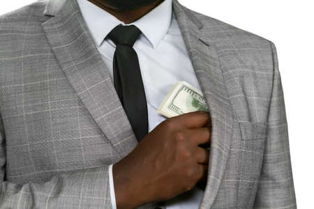 Black man hiding cash. Avoid hungry eyes. Feed the greed. It's safer to hide.の写真素材