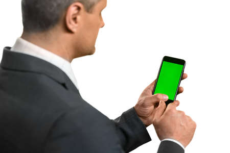 Businessman holding a smartphone. I should make a call. A useful tool. Little hepler.の写真素材