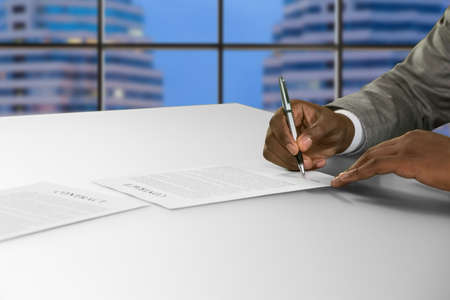 Black businessman signing a contract.の写真素材