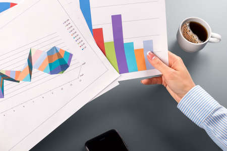 Female clerk's hands holding charts.の写真素材