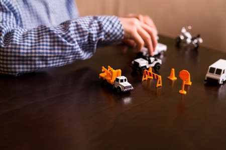 Boy's hand moves toy car. Child playing with toy cars. Imagination is power. Enjoy while you have time.の写真素材