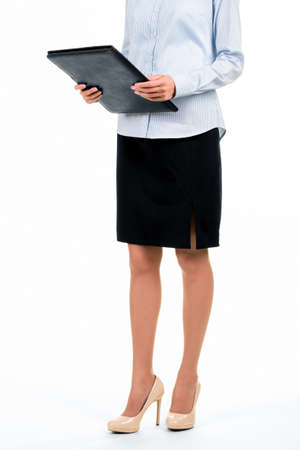Formally dressed woman with folder. Secretary holding black leather folder. Some documents you must see. Heading to chief's office.の写真素材