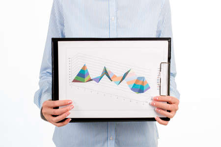 Close-up of woman's graphic charts. Businesswoman showing clipboard with diagrams. How far we've come. Definitely better than last year.の写真素材